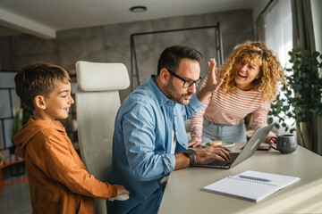 the father try to work from home while his family distracts him