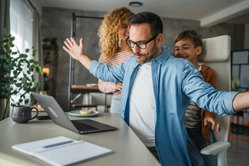the father try to work from home while his family distracts him