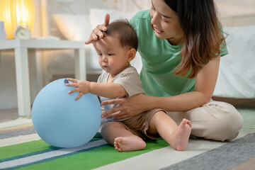 Fototapeta premium Asian baby and woman doing lifestyle activities together at home.