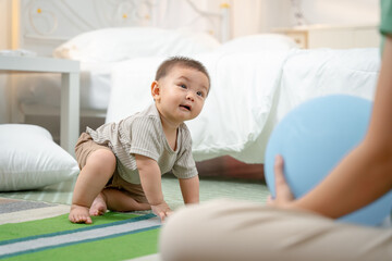 Fototapeta premium Asian baby and woman doing lifestyle activities together at home.