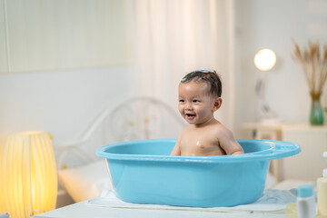 Asian baby taking a bath at home