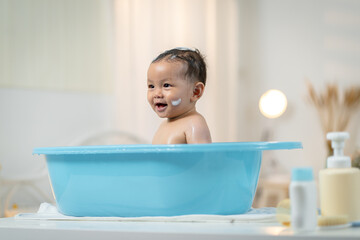 Asian baby taking a bath at home