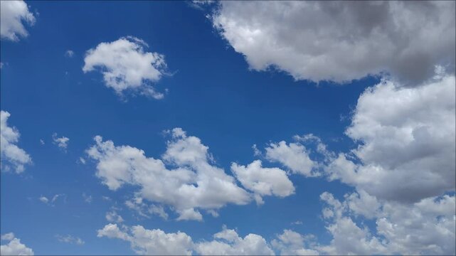 Whitish and greyish clouds in the blue sky