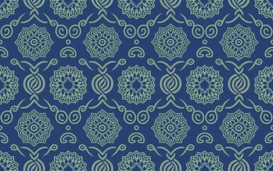 A repeating pattern of ornate, decorative motifs on a deep indigo or navy blue background.