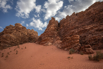 Beautiful Scenery of Sandy Dune with Red Sandstone Rock Formation in Southern Jordan. Rocky...