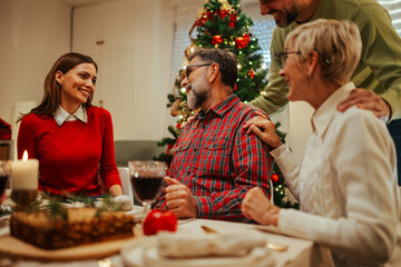Happy family celebrating christmas with festive dinner at home