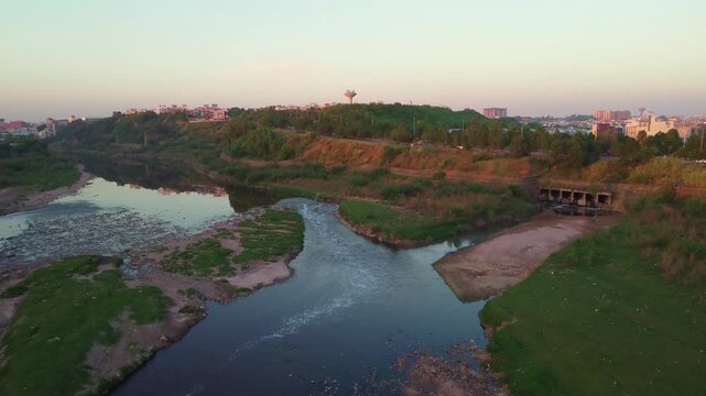 Drone hovers over the polluted Swan River, showcasing the murky waters tainted by waste, highlighting the environmental impact on this once pristine waterway.