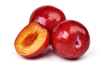 Isolated plums. One and a half of red plum fruit with leaves isolated on white background.