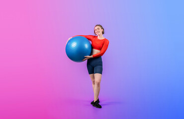 Full body length gaiety shot athletic and sporty young woman with fitness exercising ball in standing posture on isolated background. Healthy active and body care lifestyle.