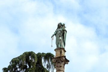 Madonna del Rosario statue atop a column at San Domenico Square in Bologna, Italy