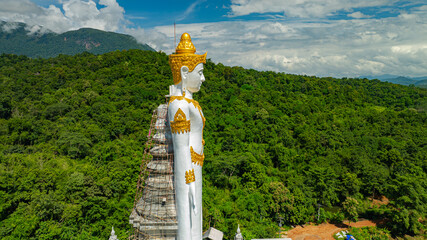 Big Buddha Brahma Panyo standing tall in front of Doi Luang mountain, Chiang Mai symbolizing peace...