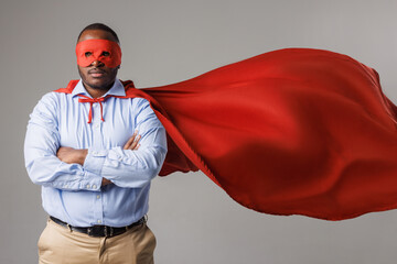serious african american man in superhero costume folding his arms isolated on white background © st.kolesnikov