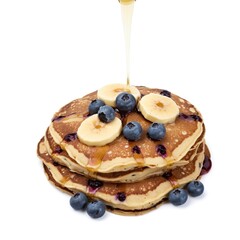 Delicious Stack of Golden-Brown Blueberry Banana Pancakes Drizzled with Maple Syrup on White Background