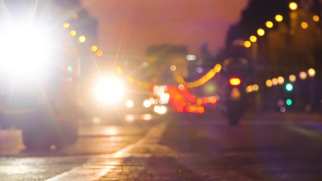 Paris City - Night Avenue - Chams Elysees and Triumphal Arch - Street Traffic - Passing Cars - Defocused Blur