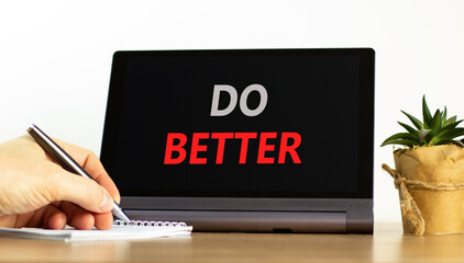 Do better symbol. Concept words Do better on beautiful black tablet. Beautiful white background. Businessman hand. Business and do better concept. Copy space.