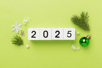 2025 with confetti and decor on color background, top view