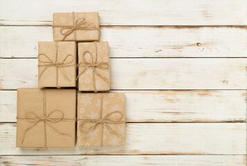 Fototapeta premium Gift boxes in Christmas tree shape on wooden background, top view