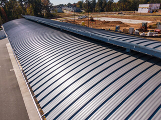 Sunny Daytime Drone Images of New Standing Seam Metal Roof on a Commercial Building