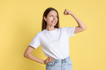 Portrait of happy winner on yellow background