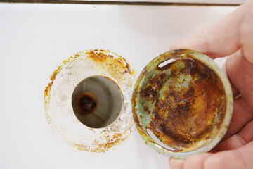 A rusted drain flap of the shower cabin in the bathroom. Plumbing breakdown and repair, replacement.