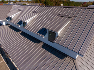 Sunny Daytime Drone Images of New Standing Seam Metal Roof on a Commercial Building