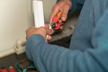 Hands of a professional technician working in energy efficiency.

