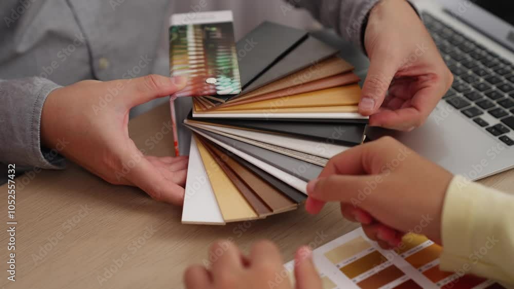 Poster slow motion hand closeup of professional architect and interior designer presenting material and col