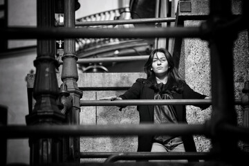 A woman standing at a fence