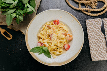 Creamy pasta with shrimp, mushrooms, Parmesan, and fresh basil, served in an elegant setting
