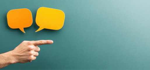 Hand pointing at speech bubbles on green background for communication concept