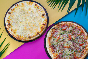 Pepperoni and tomato pizza on a vibrant tropical backg