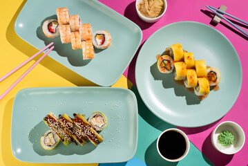 Colorful Sushi Rolls with Chopsticks and Dipping Sauces