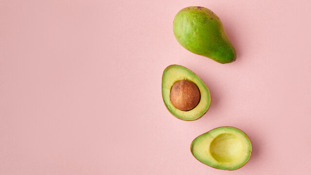 Avacado placed on pink surface