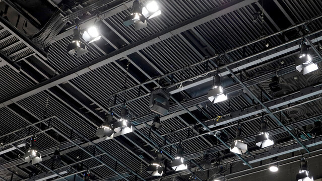 A large studio ceiling rig with exposed structure and many hanging spotlights