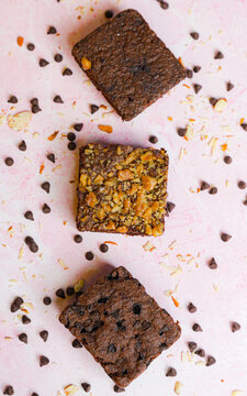 Chocolate cookies with choco chips on pink surface