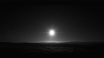 Fototapeta premium A bright star shines brightly in the dark sky over a tranquil mountain horizon