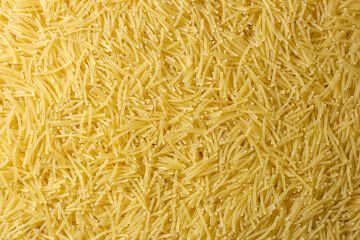 Uncooked Filini Pasta: A Culinary Canvas of Noodles, Creating a Lively and Textured Background for Gourmet Cooking. Dry Pasta. Raw Macaroni - Top View, Flat Lay