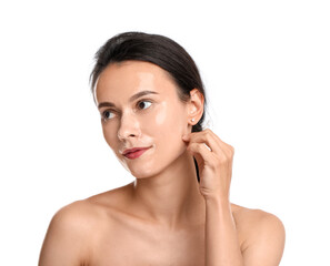 Beautiful woman peeling off face mask on white background