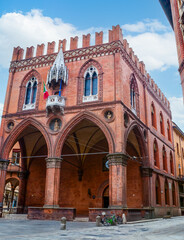 Palazzo della Mercanzia, the gothic styled facade with white balcony, Bologna, Italy