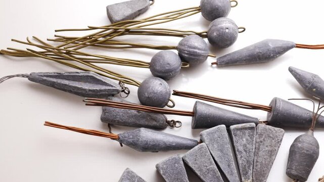 Old lead fishing sinkers on a white background. fishing tools.