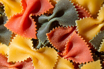 Uncooked Vibrant Colored Farfalle Pasta: A Culinary Canvas of Multicolored Bow-Tie Macaroni,...