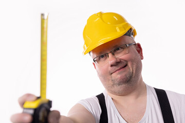 A dedicated Construction Worker who is expertly using a Measuring Tape in outdoor settings