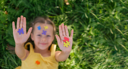 A banner with a place to copy on the topic of awareness about autism. A girl shows multicolored...