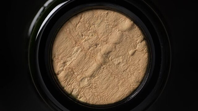 Close up of wine cork inside glass bottle, not opened bottle of wine, top view, rotates