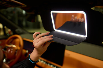 The modern car interior features a sleek vanity mirror that highlights both functionality and style