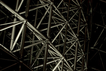 A huge structure with a geometric design made up of many steel pipes