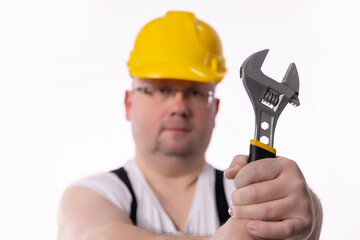 A Construction Worker Holding an Adjustable Wrench, Showcasing Skills and Dedication