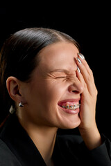 Bright young woman with braces smiling with open mouth