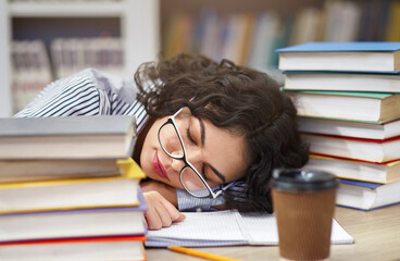 Sleeping At Library. Tired mexican girl student napping on books stack, being exhausted during preparing for exams