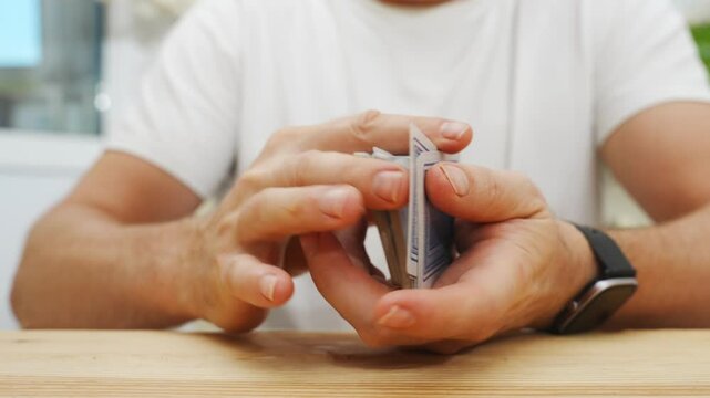 male hands shuffle a deck of playing cards. gambling. A board game for spending leisure time with friends and family.